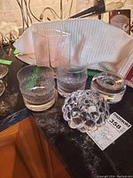 Two textured Ultima Thule tumblers, Orrefors bubble-pattern and cylindrical holders on counter