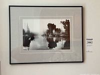 Framed black and white photograph showing boats at Oakville Harbour with artist signature.