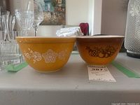 Two vintage Pyrex mixing bowls side by side showing exterior patterns and sizes