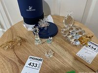 Overview of all items: lionfish, cats, pineapple, grape cluster, teardrop crystal, ring accessory and Swarovski box lid