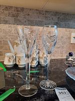 Two Waterford crystal glasses placed on a counter with other kitchen items in the background.