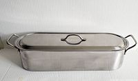 Side view of stainless steel rectangular fish poacher with lid and handles