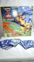 Pokemon Battle Academy board game box with Charizard and Pikachu artwork. Game is new/unused and complete, box shown front and center.