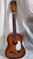 Full front view of vintage Global steel neck acoustic guitar showing entire body and headstock with tuning pegs.