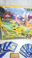 Photo showing Pokemon Battle Academy board game box with main cover featuring Pikachu and other characters.