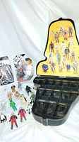 Wide shot of open Darth Vader case with two carded figures and loose action figures