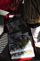 Christmas decorations including napkins, poinsettia flowers, candle holder, candles and figurines with a fur-trimmed item