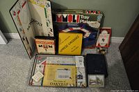 Front view of all vintage games displayed including boards, boxes, and game components.