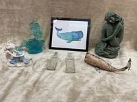 Photo showing the full set of decorative items including three mermaid figurines, framed whale artwork, two glass bottles, and a metal whale sculpture.