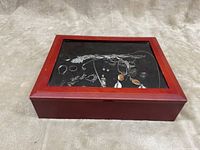 Wooden jewelry display case with glass top showing the silver jewelry inside.