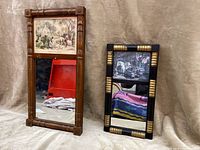 Two antique decorative mirrors side by side on a beige fabric background showing frames and pictures above mirror glass.