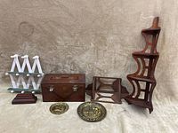 Collection showing all items on beige cloth: vintage wooden box with initials, white and green shelf, two smaller brown wooden shelves, tall corner curved shelf, and two gold-colored medallions.