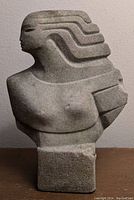 Front view showing the bust with styled hair and visible natural stone texture and chips.