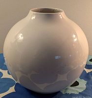 Photo of large white spherical vase showing glossy surface and approximate size.