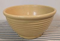 Side view of vintage Pfaltzgraff York mixing bowl showing cream color and ribbed exterior detail.