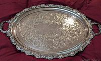 Full view of the large oval silverplated tray showing the engraved surface and ornate edge.