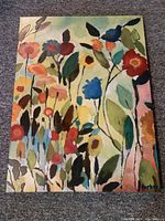 Full view of the colorful abstract floral painting on canvas.