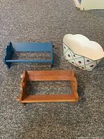 Top-down view of the two wooden bookshelves, one blue and one natural wood, alongside the decorative ladybug bin showing size and condition.