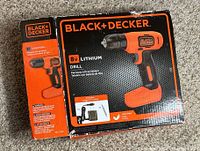 Black+Decker 8V Lithium drill in original box showing front of packaging with drill image and included items.