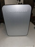 Closed mini fridge showing brushed metal front with Frigidaire logo.