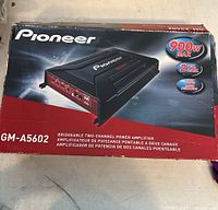 Box showing Pioneer GM-A5602 amplifier with 900W max power, 2 channels, and bridgeable feature.