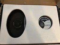 Pair of Pioneer TS-D6902R car speakers in original box with foam inserts visible, showing the speaker cone and label with model and power details.