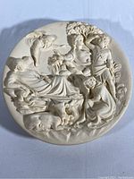 Full front view of the round relief plate showing the nativity scene with multiple figures and animals.