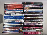 Top-down view of all DVDs and the Mr Bean VHS tape arranged on a flat surface showing titles and spine details.