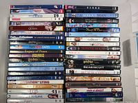 Full view of 42 DVDs stacked in two columns showing titles and cases.