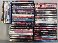 View of 47 DVDs stacked vertically showing a diverse collection of movie and series titles including multi-disc sets.