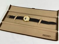 Full view of the Seiko women's quartz watch in beige felt-lined hard shell gift box, showing the watch and box interior with SEIKO logo.