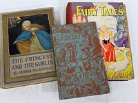 Three vintage children's books laid out side by side. Front covers include The Princess and the Goblin, Grimm's Fairy Tales and Dairy Tales of the Grimm Brothers.