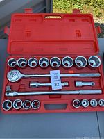 Full view of 12 piece socket set in open red plastic case showing all components in place.