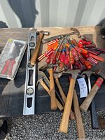 Overview of assorted screwdrivers, hammers, level and rivet gun closed in plastic case