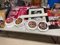 Table display showing six NASCAR collector plates featuring various drivers.
