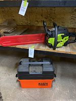Poulan P3314 chainsaw with 14-inch Oregon bar cover and Klein Tools toolbox on wooden shelf.