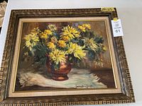 Front view of framed floral still life painting