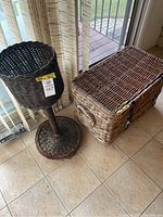 Wicker chest and plant stand placed on tile floor next to window
