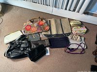 Overview of all 12 purses including floral handbag, black and white clutches, and others