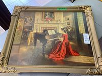 Full frontal view of the framed print showing the woman in a red dress playing piano inside an elegant room with floral and decorative elements.