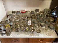 Wide view of the Mason and Crown jars in various sizes with metal lids and rings