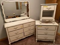 Six-drawer dresser with scalloped apron, ornate pulls under mounted mirror
