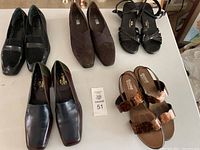 Overview of five pairs of women's shoes in various styles and colors