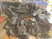Overview photo showing all four black duffle bags of varying sizes laid out on a flat surface.