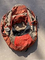 Top view of the belly boat showing storage pockets and seat area with tan and orange colors.