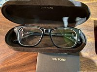 Tom Ford prescription glasses inside branded soft-lined hard case showing front and lenses.