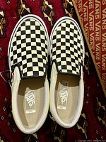 Top view of Vans Slip-On Pro shoes showing the checkerboard pattern on the upper and the Vans logo on the insole.