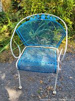 Retro metal outdoor chair with blue mesh seat and backrest, white fan-shaped decorative frame