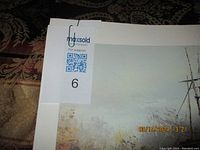 Close up of print corner showing signature and matting edges with minor marks from storage.