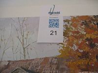 Close-up photo of the artwork showing branches and part of the barn roof, with auction tag.